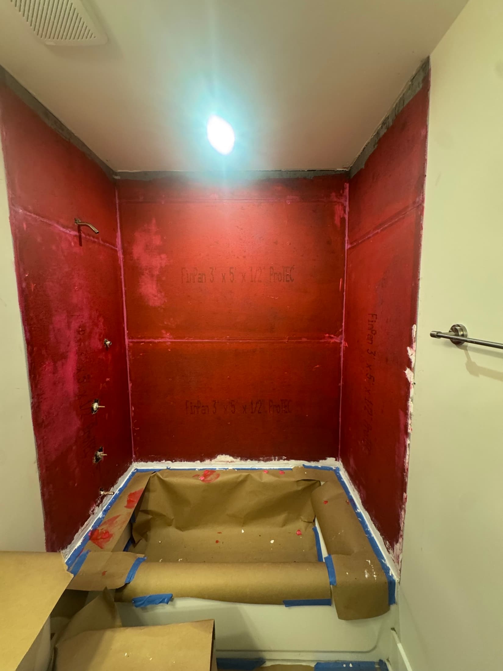 Waterproofing membrane rolled over backer board before tile