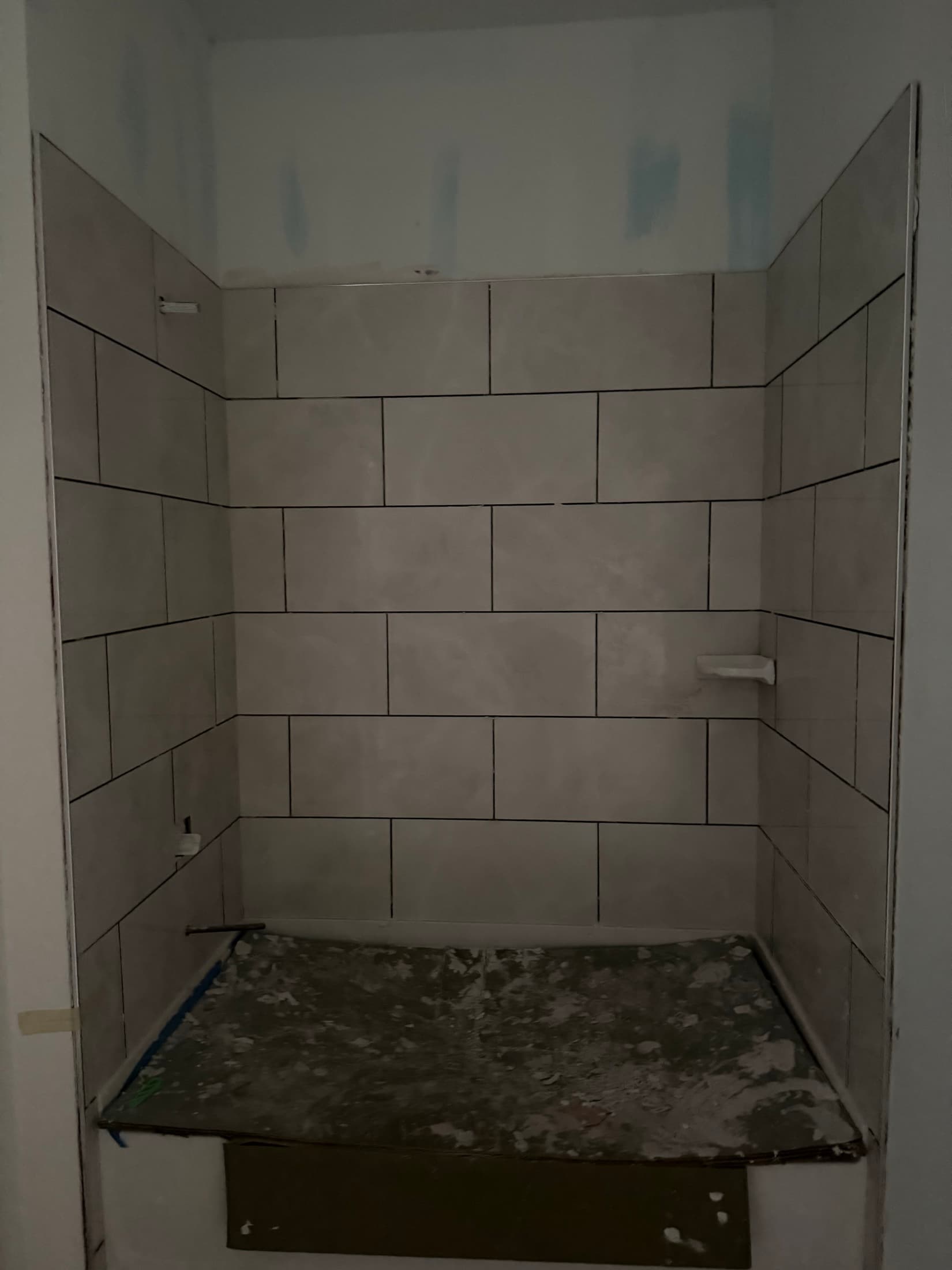 Finished large-format tile tub surround with dark grout