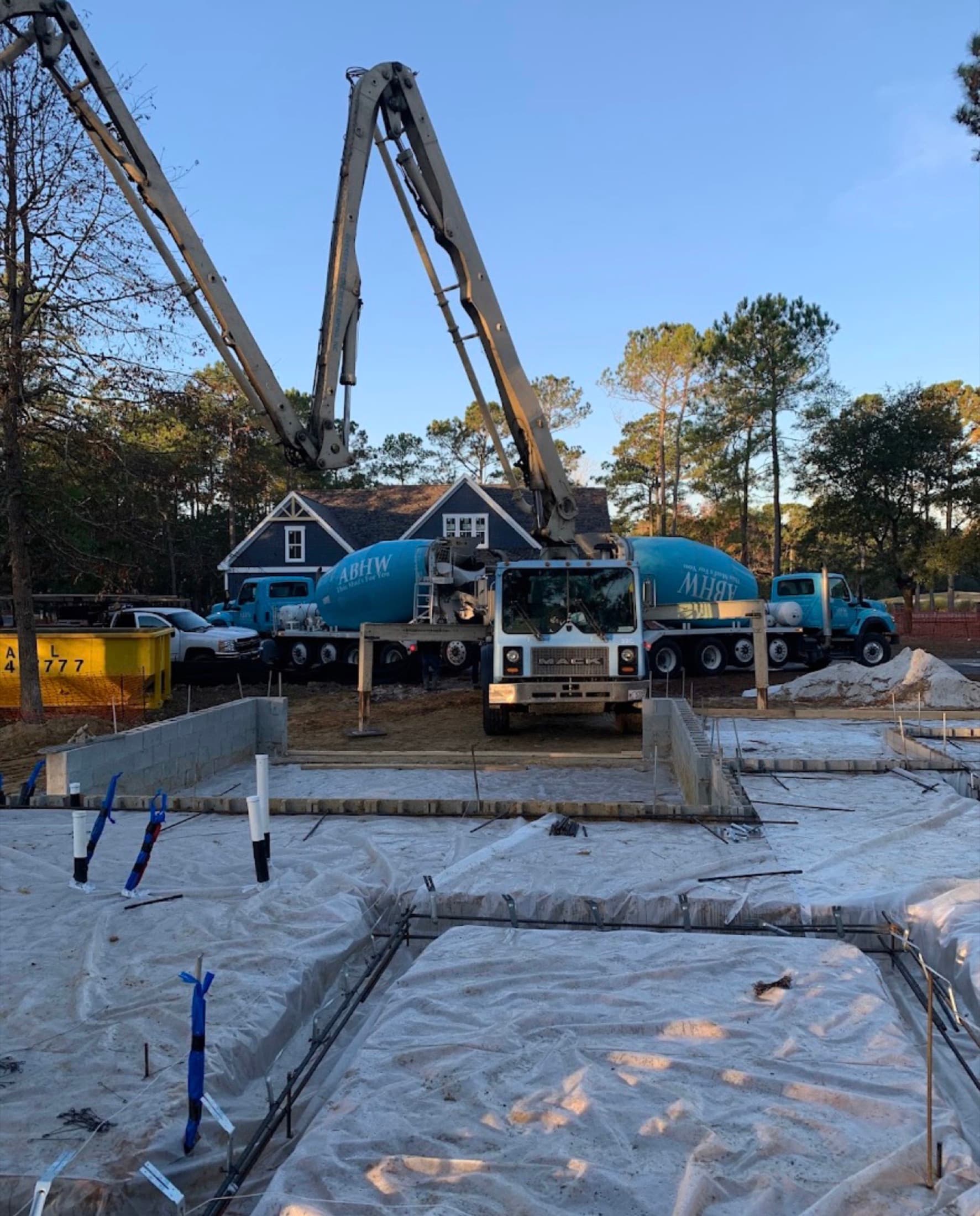 Slab prep with vapour barrier, rebar and a concrete pump truck on site