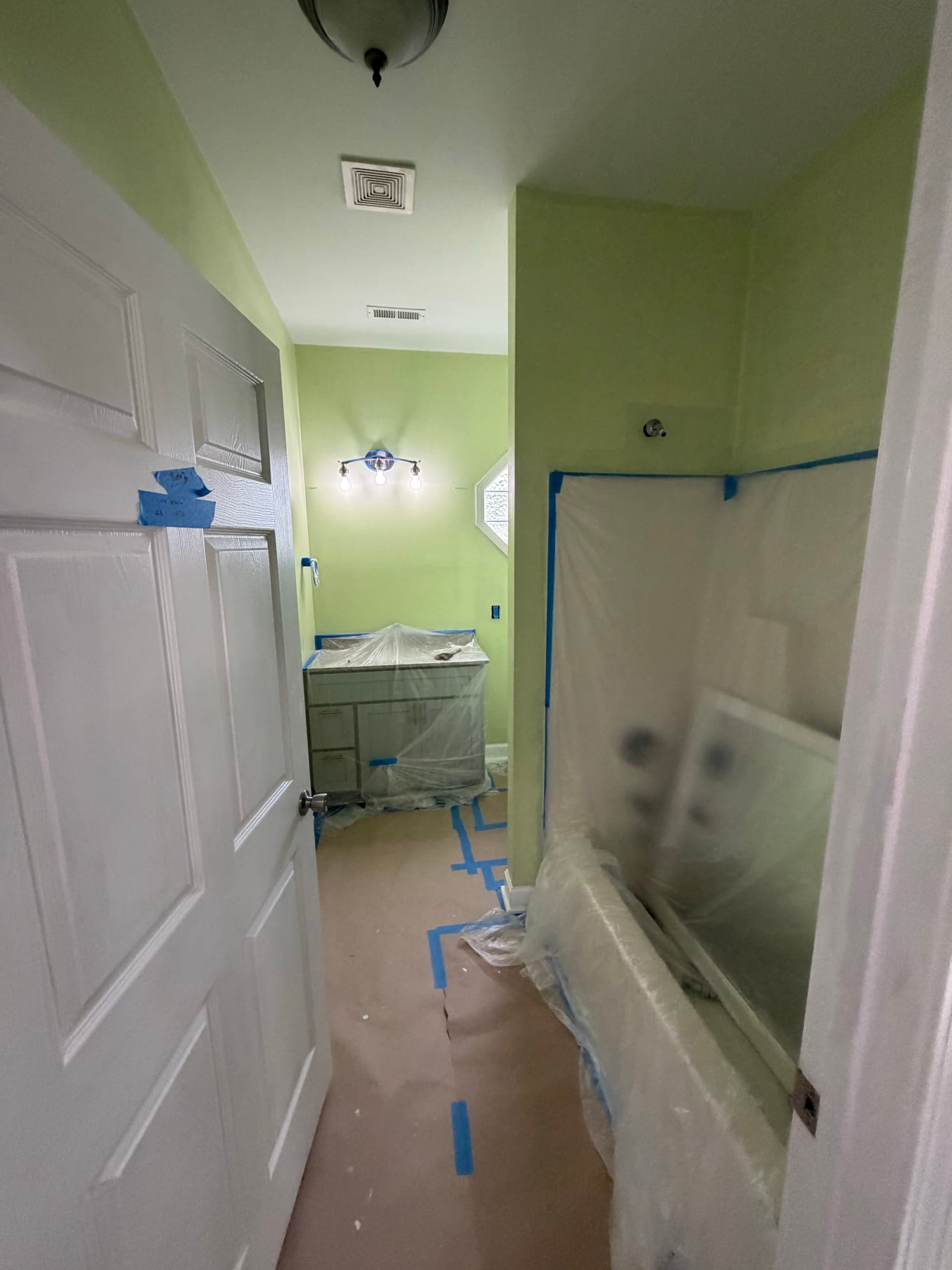 Bathroom masked off with vanity and tub covered