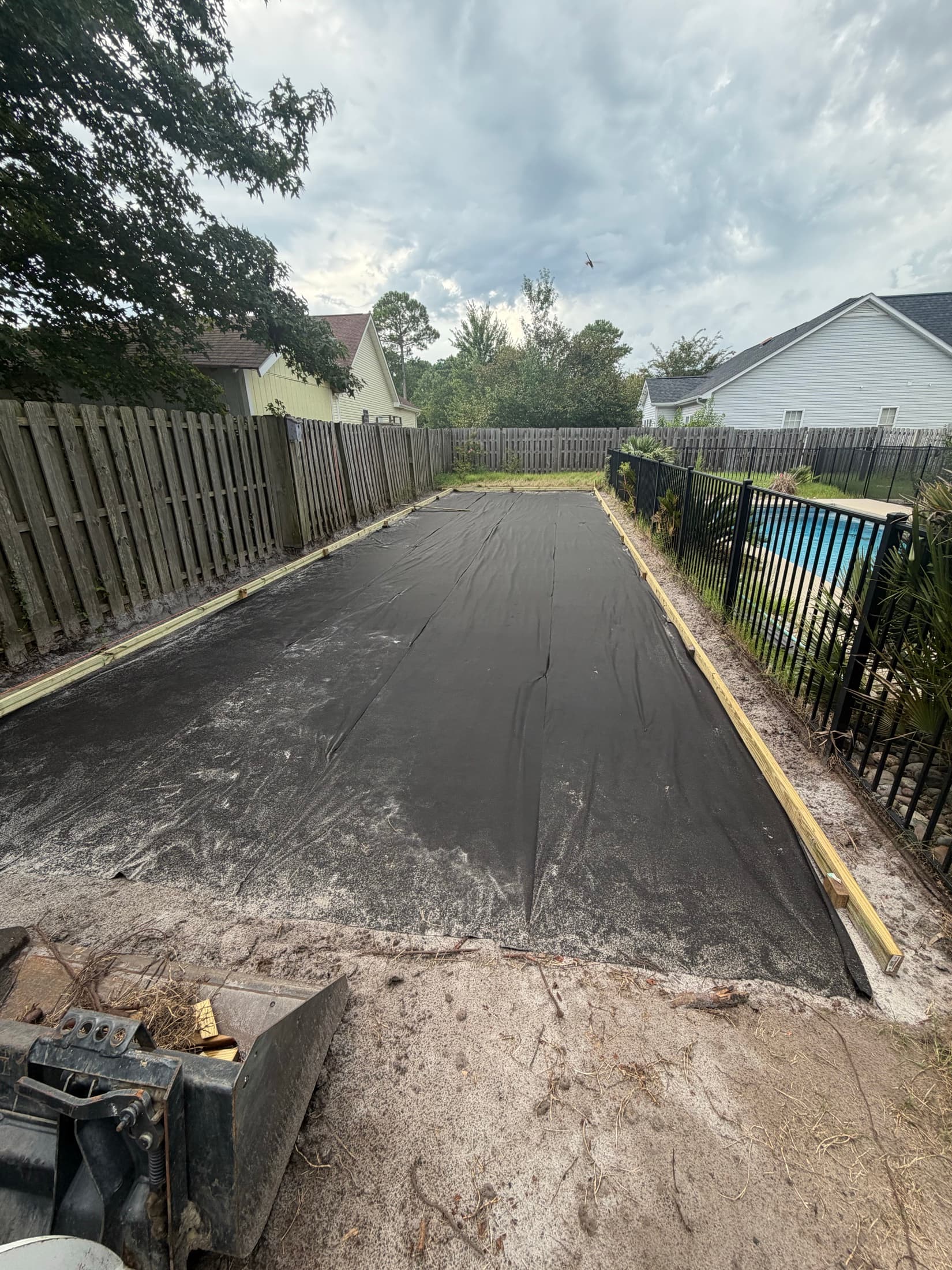 Compacted base with weed barrier and timber borders